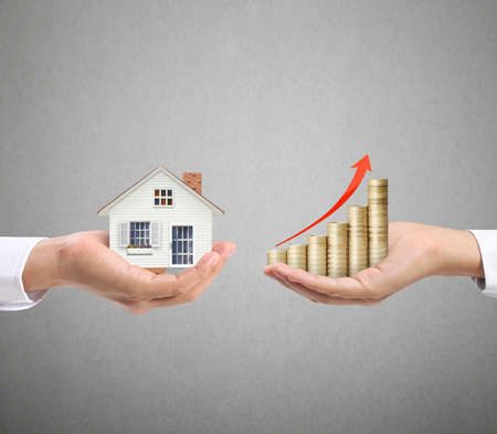 holding house representing home ownership and the Real Estate business の写真素材