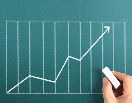 Business man drawing a graph 
