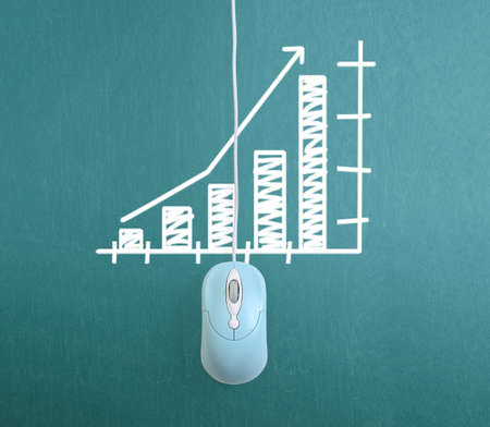 Wireless computer mouse on blackboardの写真素材