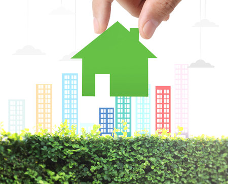 holding house representing home ownership and the Real Estate business の写真素材