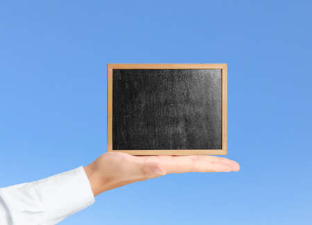 businessman holding a blank blackboard の写真素材