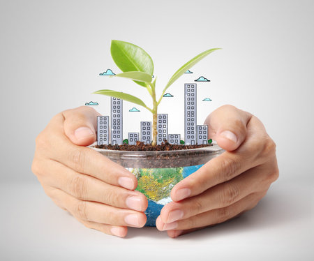 concept miniature globe showing, holding glowing earth globe in his handsの写真素材
