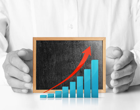 Hands holding blackboard with chartの写真素材