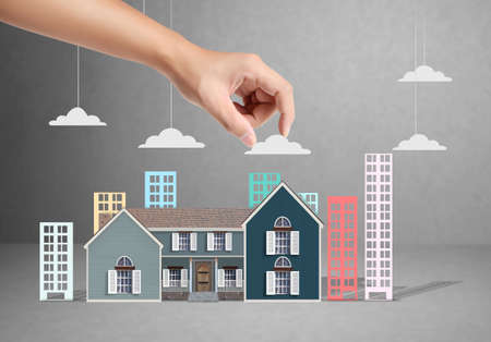 property insurance concept , man protect model of the houseの写真素材