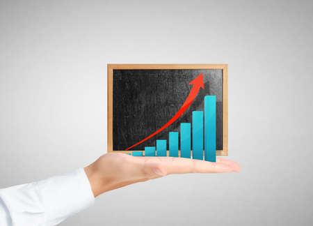 Hands holding blackboard with chartの写真素材