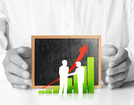 Hands holding blackboard with chartの写真素材