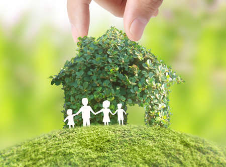 holding house representing home ownership and the Real Estate businessの写真素材