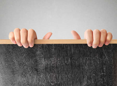 man holding blank chalkboard in the handの写真素材