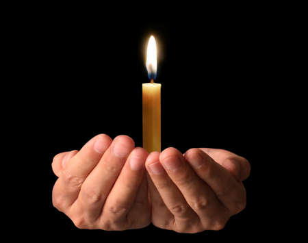 Man Praying Hands with candleの写真素材