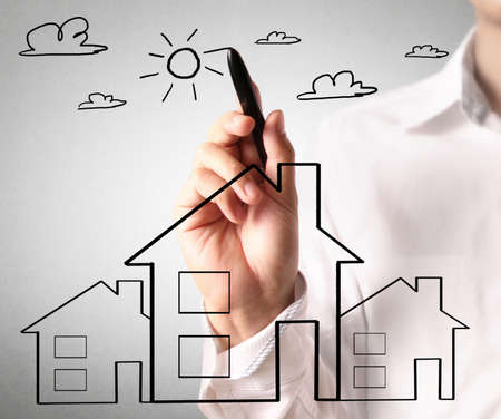 Man drawing a growing real estate chartの写真素材
