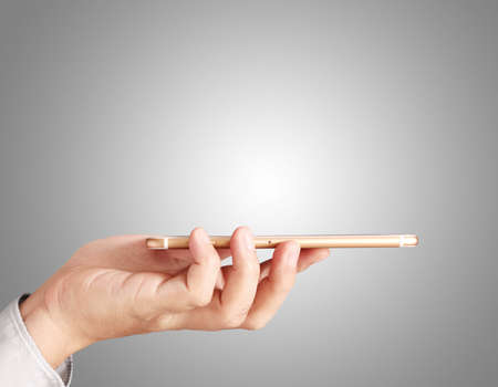 Close up hand holding smart phoneの写真素材