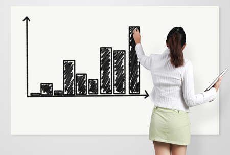Business woman showing Graph on the boardの写真素材