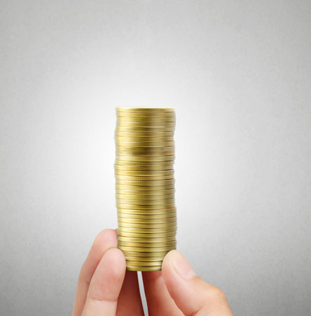Gold coins in hand