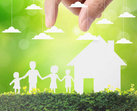 holding house representing home ownership and the Real Estate businessの写真素材