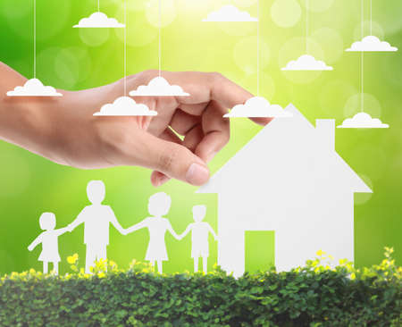 holding house representing home ownership and the Real Estate businessの写真素材