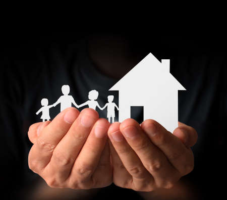 House and family of paper in hand businessmenの写真素材