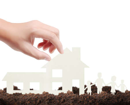 holding house representing home ownership and the Real Estate businessの写真素材