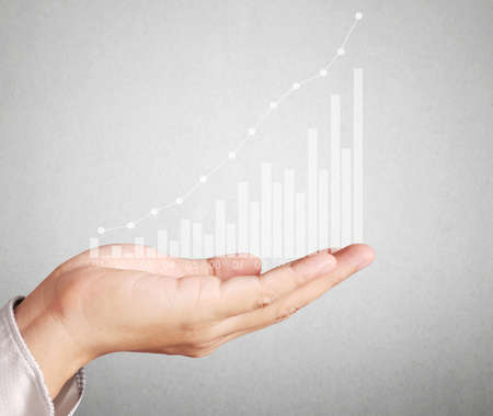 Investment concept,businessman with financial symbols coming from handの写真素材