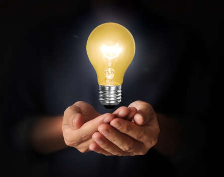 Energy saving light bulb, Creative light bulb idea in the handの写真素材