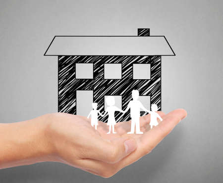 holding house representing home ownership and the Real Estate businessの写真素材
