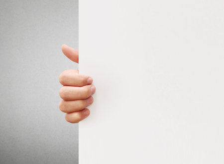 holding white a blank A4 paperの写真素材