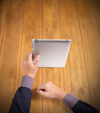 hands holding and pointing on contemporary digital tabletの写真素材