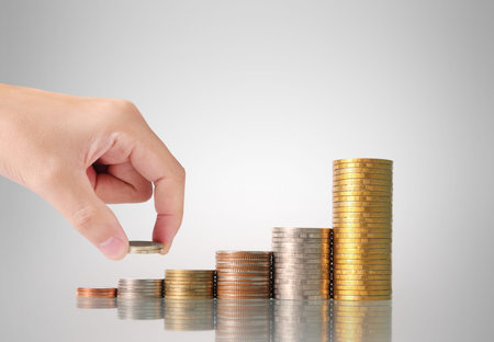 Hand human hand putting coin to money, business ideas
