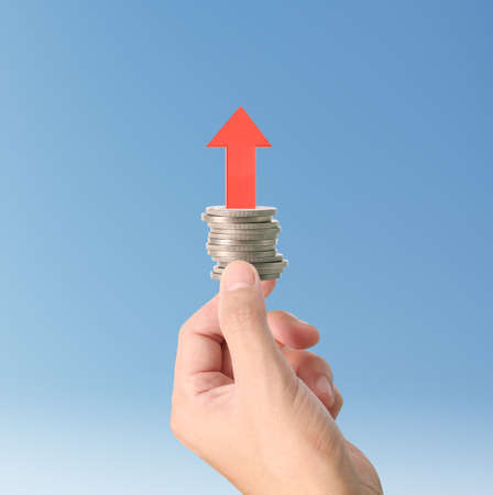 Hand human hand putting coin to money, business ideasの写真素材