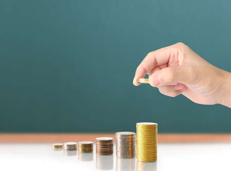 Hand human hand putting coin to money, business ideasの写真素材