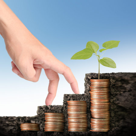Hand human hand putting coin to money, business ideasの写真素材