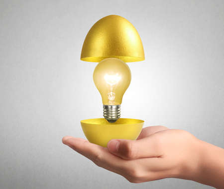 Hand Holding of golden eggsの写真素材