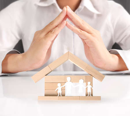 holding house representing home ownership and the Real Estate businessの写真素材