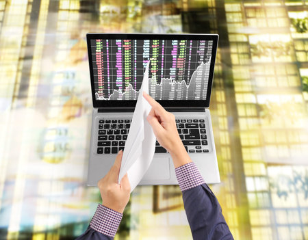 Hand holding white a blank paper sheetの写真素材