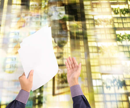 Hand holding white a blank paper sheetの写真素材