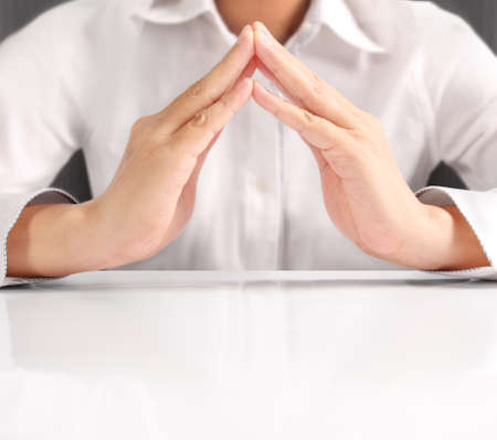 holding house representing home ownership and the Real Estate businessの写真素材