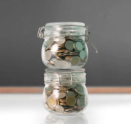 Silver coins in a piggy bank Glassの写真素材
