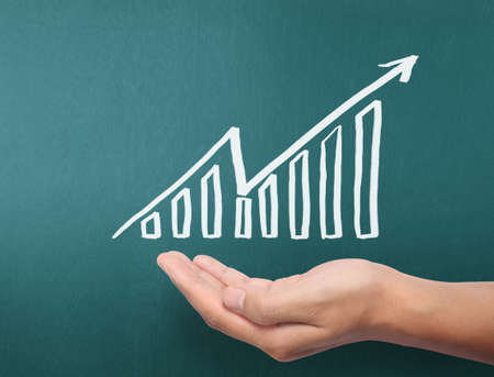 drawing results graph with white chalk on blackboardの写真素材