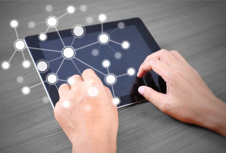 Close up hands multitasking man using tablet