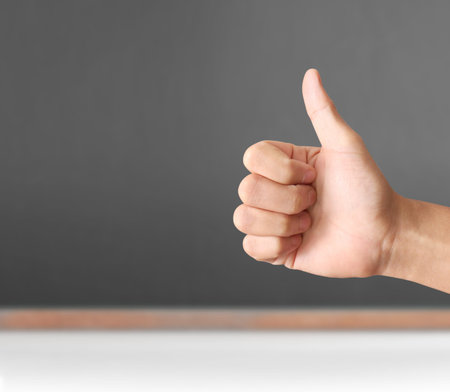 Hand shown thumb up isolated
