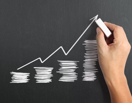 drawing results graph with white chalk on blackboardの写真素材