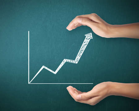 drawing results graph with white chalk on blackboardの写真素材