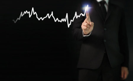 Investment concept,hand with stock financial chart symbols coming from handの写真素材