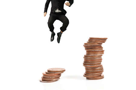 Businessman walk on stack of coins which grows success and investmentの写真素材
