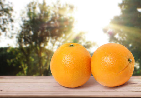 orange  on white a wooden tableの写真素材