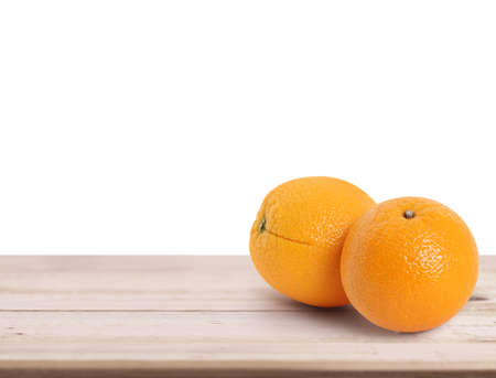 orange  on white a wooden tableの写真素材
