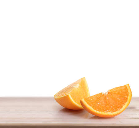 orange  on white a wooden tableの写真素材