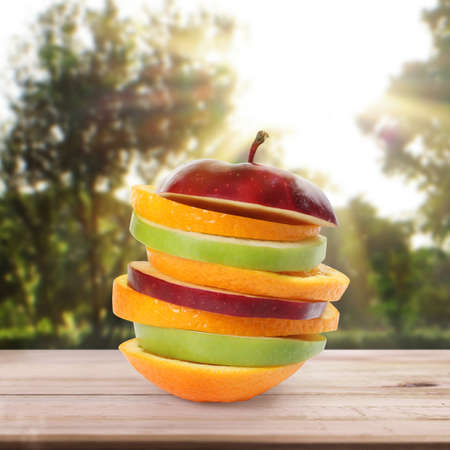 apple and orange on white a wooden tableの写真素材