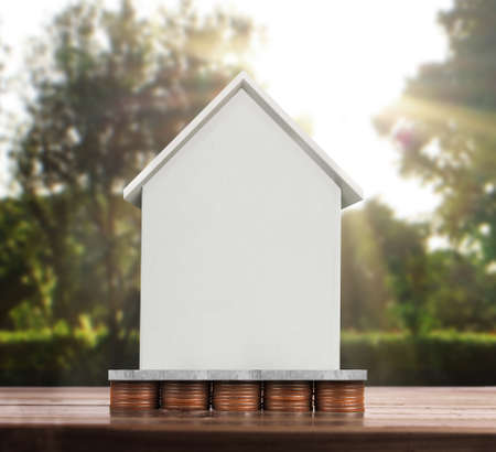 House on a pile of coins,moneyの写真素材