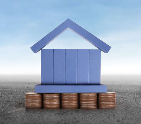 House on a pile of coins,moneyの写真素材