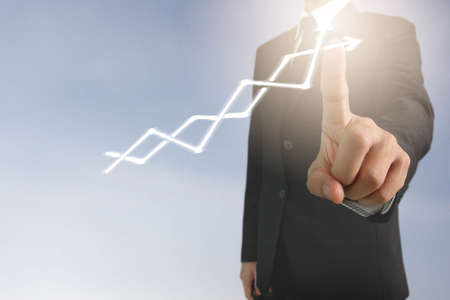 Businessman plan graph growth and increase of chart positive indicators in his businessの写真素材